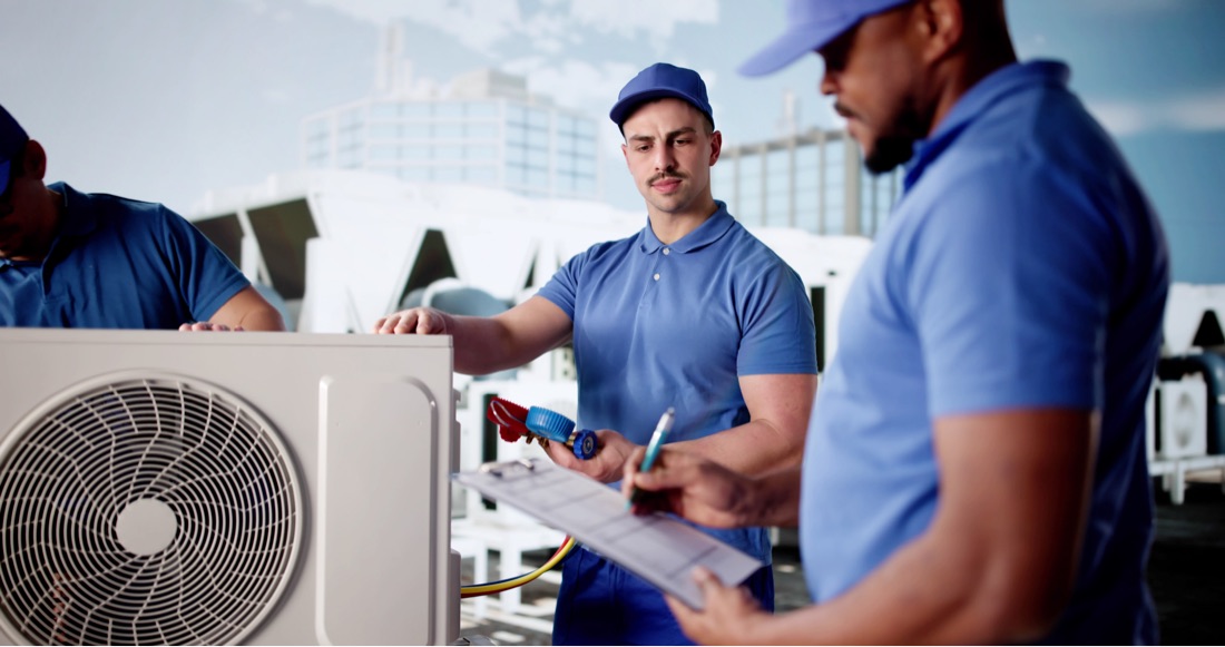 Two technicians analyzing a cooling system on a jobsite
